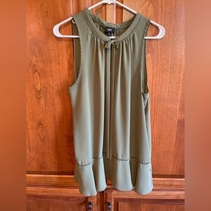 Like new sleeveless blouse with tie front and drop waste.